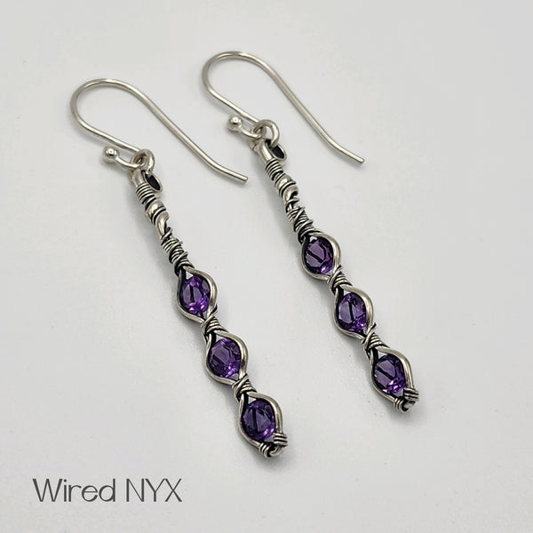 Natural Amethyst Gemstone Earrings Wire Wrapped in Sterling Silver (Oxidized) Material: Sterling Silver (Oxidized) Stones: Natural Amethyst Earring length: 51mm