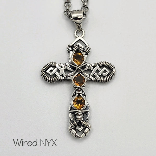 Natural Citrine Wire Wrapped Cross Pendant in Sterling Silver (Oxidized) Material: Sterling Silver (Oxidized) Stones: Natural Citrine Pendant height: 36mm Pendant width: 23mm Chain: Stainless Steel Round Rolo Chain (3mm) ~ Choose Length 18"-30" Inches