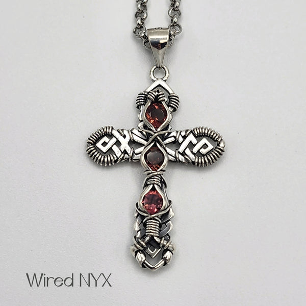 Natural Pink Topaz Gemstone Wire Wrapped Cross Pendant in Sterling Silver (Oxidized) Material: Sterling Silver (Oxidized) Stones: Natural Pink Topaz Pendant height: 36mm Pendant width: 23mm Chain: Stainless Steel Round Rolo Chain (3mm) ~ Choose Length 18"-30" Inches